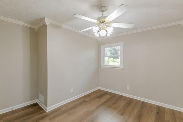 unfurnished room featuring hardwood / wood-style flooring, ceiling fan, and crown molding