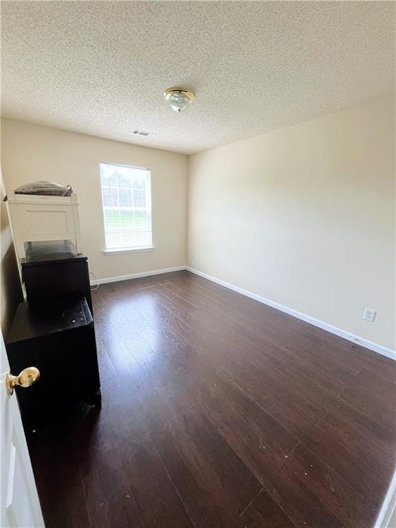 7104 Georges Way, Morrow, GA 30260 - unfurnished living room with dark wood finished floors and a textured ceiling