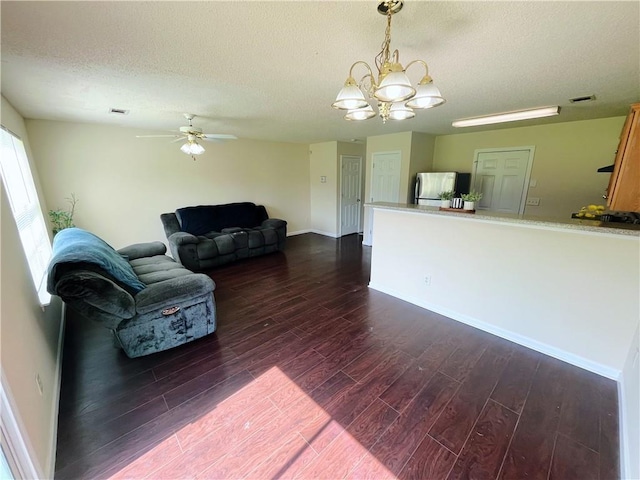 7104 Georges Way, Morrow, GA 30260 - living area with dark wood finished floors, a textured ceiling, ceiling fan, and a chandelier