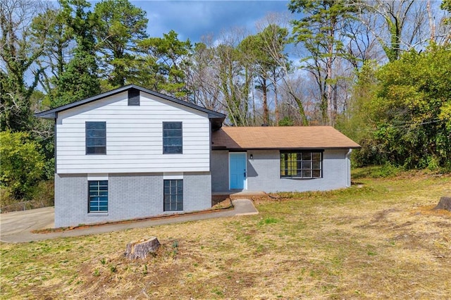 split level home featuring a front lawn