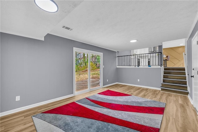 living room with wood-type flooring and a textured ceiling