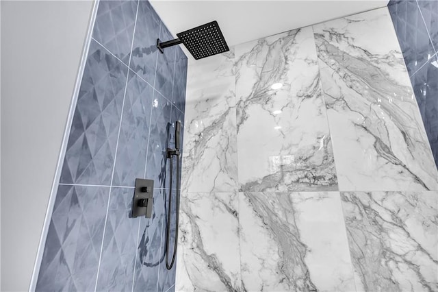 interior details with a tile shower