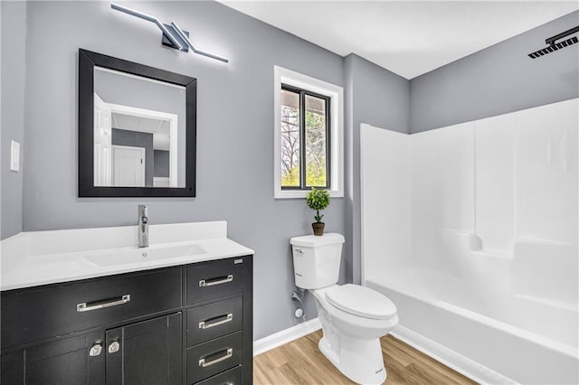 full bathroom featuring vanity, wood-type flooring, shower / washtub combination, and toilet