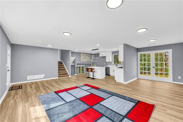 interior space with french doors and light hardwood / wood-style flooring