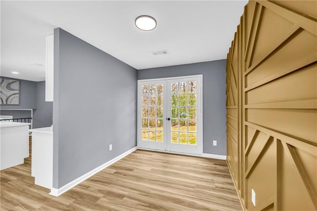 interior space featuring french doors and light hardwood / wood-style floors