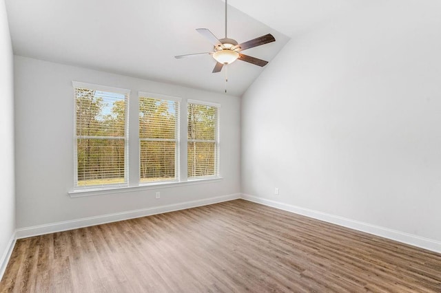 unfurnished room featuring plenty of natural light, wood finished floors, and baseboards