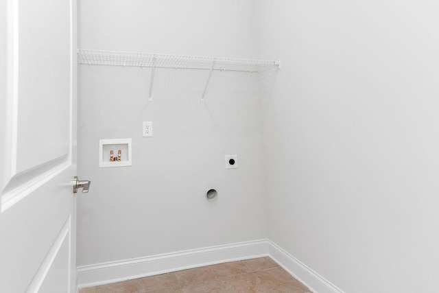 laundry room with laundry area, hookup for an electric dryer, hookup for a washing machine, baseboards, and light tile patterned flooring