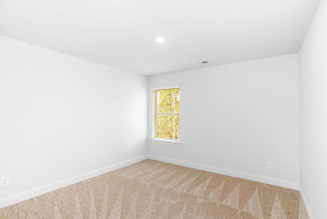 carpeted empty room featuring visible vents, baseboards, and recessed lighting