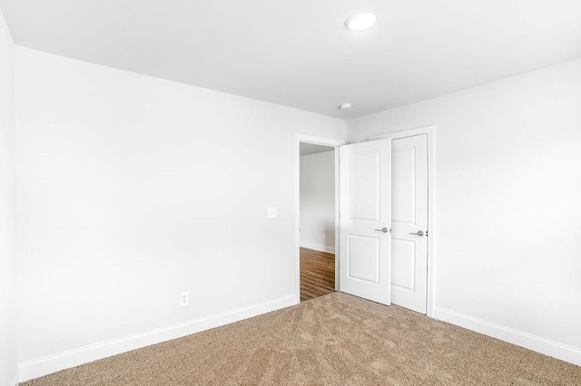 unfurnished bedroom featuring carpet, baseboards, and recessed lighting