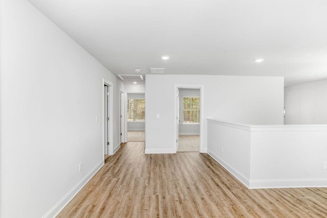 unfurnished room with visible vents, wood finished floors, baseboards, and recessed lighting