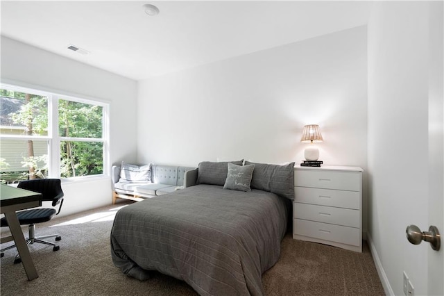 carpeted bedroom with baseboards and visible vents