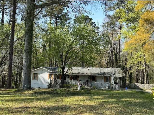 ranch-style home with covered porch and a front lawn