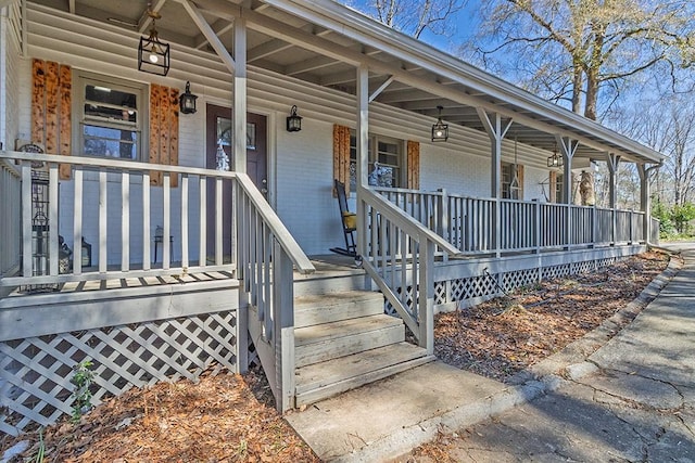 property entrance featuring brick siding and covered porch