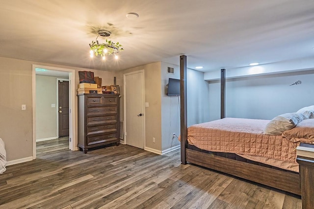 bedroom featuring visible vents, baseboards, and dark wood-type flooring