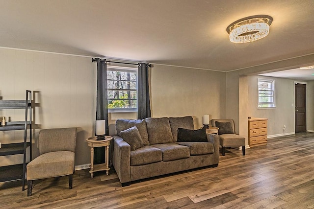 living room with plenty of natural light, wood finished floors, and baseboards