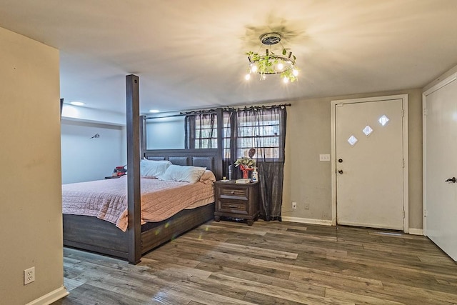 bedroom featuring baseboards and wood finished floors