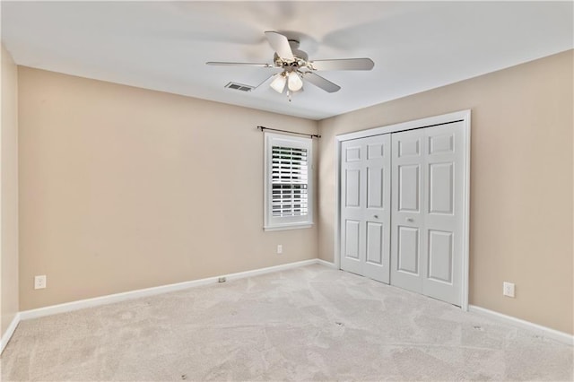 unfurnished bedroom with visible vents, carpet flooring, baseboards, and a closet