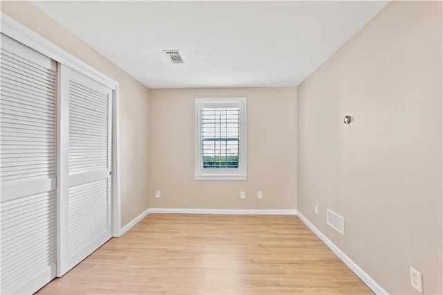 unfurnished bedroom with baseboards, visible vents, and light wood finished floors