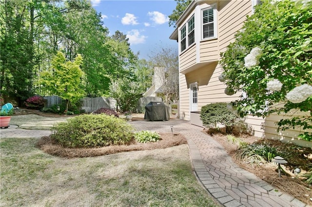 view of yard featuring fence and a patio area