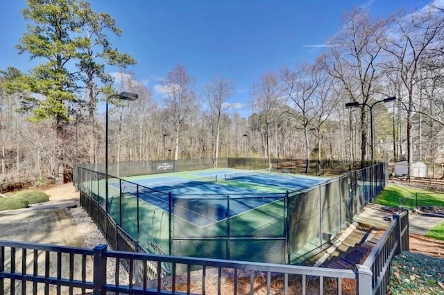 view of tennis court with fence