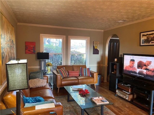 living room with a textured ceiling, hardwood / wood-style flooring, and crown molding