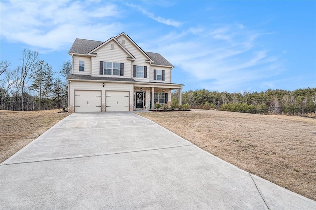 view of front of property featuring a garage, a front yard, and concrete driveway