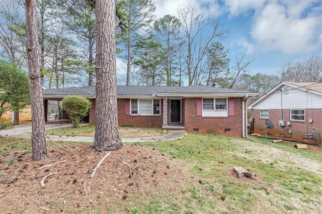 ranch-style house with brick siding, crawl space, an attached carport, driveway, and a front lawn