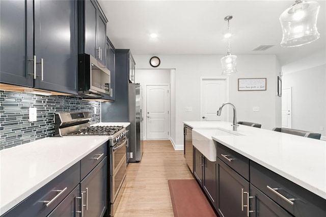 138 Daffodil Lndg, Dallas, GA 30132 - kitchen with appliances with stainless steel finishes, a sink, tasteful backsplash, and light countertops