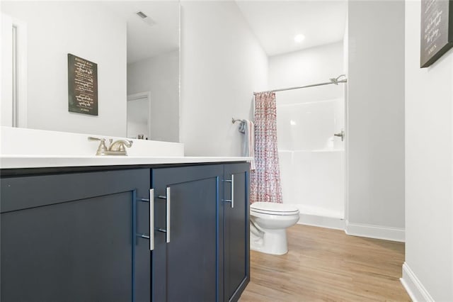138 Daffodil Lndg, Dallas, GA 30132 - full bathroom featuring toilet, vanity, wood finished floors, a shower with shower curtain, and baseboards