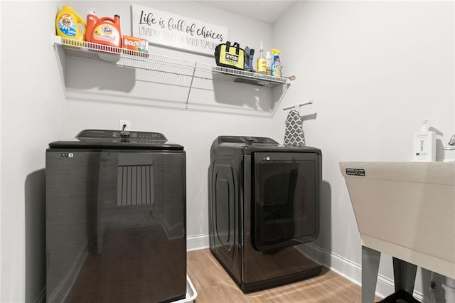 138 Daffodil Lndg, Dallas, GA 30132 - laundry area featuring washing machine and clothes dryer, wood finished floors, and baseboards