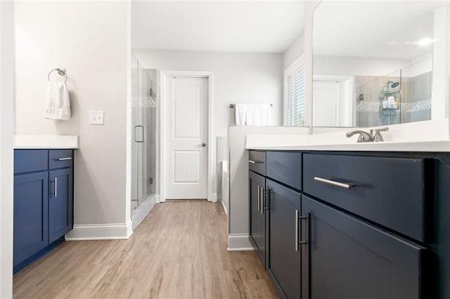 138 Daffodil Lndg, Dallas, GA 30132 - full bathroom featuring a stall shower, vanity, wood finished floors, and baseboards