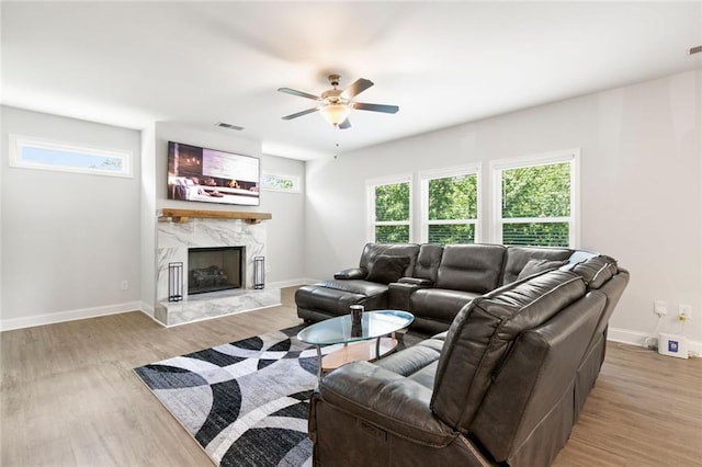 138 Daffodil Lndg, Dallas, GA 30132 - living area with light wood-type flooring, ceiling fan, a fireplace, and baseboards