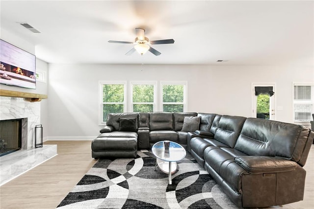 138 Daffodil Lndg, Dallas, GA 30132 - living area featuring ceiling fan, a high end fireplace, light wood-style flooring, and baseboards