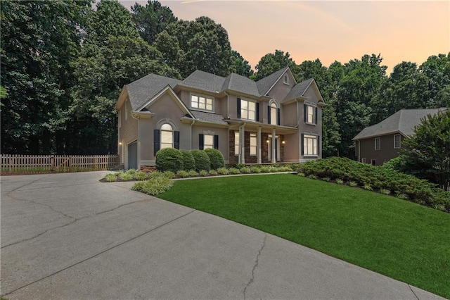 view of front of property featuring a yard and a garage