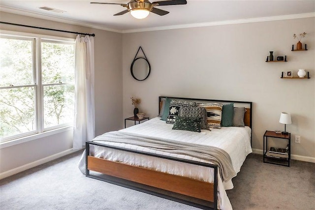 bedroom with ceiling fan, ornamental molding, and carpet