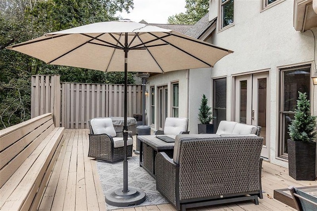 wooden deck with french doors and an outdoor hangout area