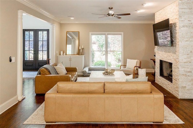 living room featuring dark hardwood / wood-style flooring, crown molding, and a wealth of natural light