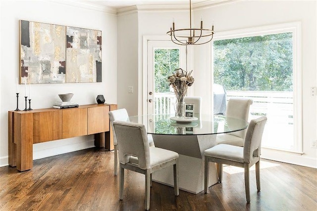 dining space with a notable chandelier, crown molding, and dark wood-type flooring