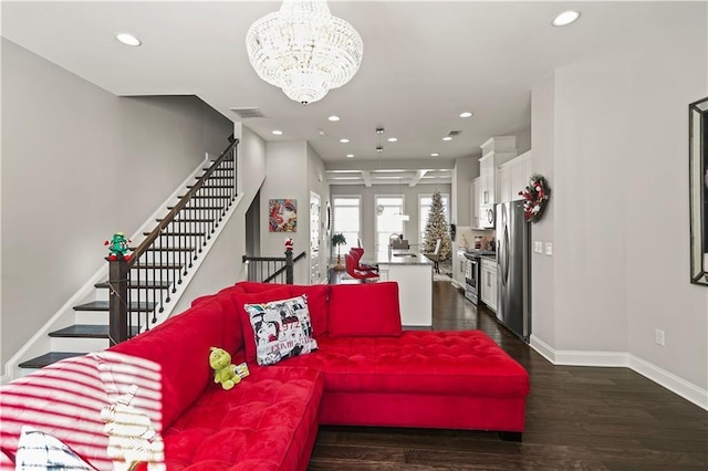 living room featuring dark hardwood / wood-style floors and an inviting chandelier