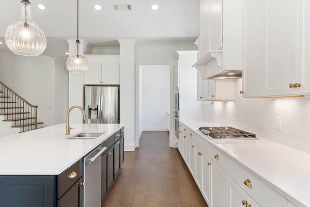 3610 Burnt Bridge Rd, Cumming, GA 30028 - kitchen with stainless steel appliances, a sink, light countertops, tasteful backsplash, and white cabinets
