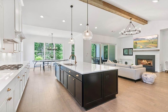 3610 Burnt Bridge Rd, Cumming, GA 30028 - kitchen with stainless steel appliances, a chandelier, a sink, white cabinetry, and healthy amount of natural light