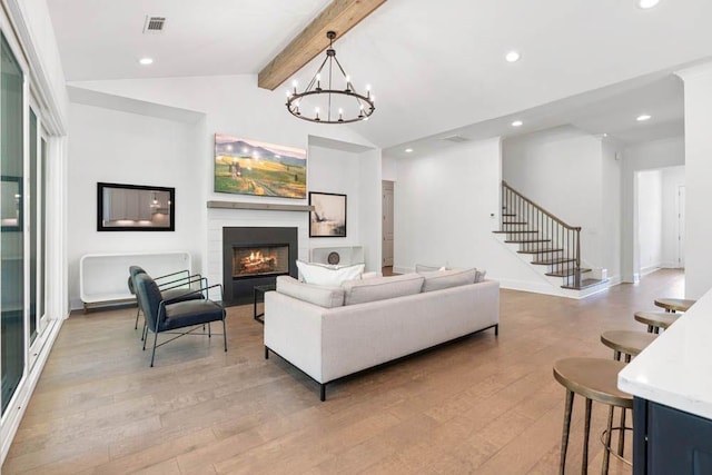 3610 Burnt Bridge Rd, Cumming, GA 30028 - living area featuring light wood-style flooring, a lit fireplace, recessed lighting, stairway, and a chandelier