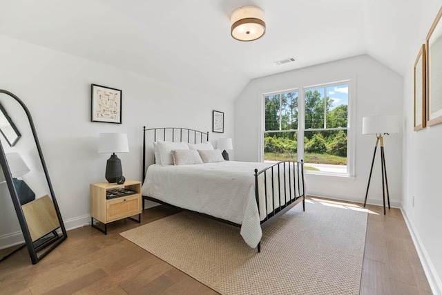 3610 Burnt Bridge Rd, Cumming, GA 30028 - bedroom featuring vaulted ceiling, baseboards, and wood finished floors