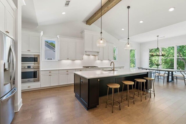 3610 Burnt Bridge Rd, Cumming, GA 30028 - kitchen featuring appliances with stainless steel finishes, a sink, light countertops, tasteful backsplash, and light wood-style floors