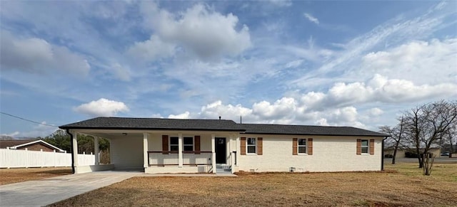 view of front of house featuring a front yard, a carport, and a porch