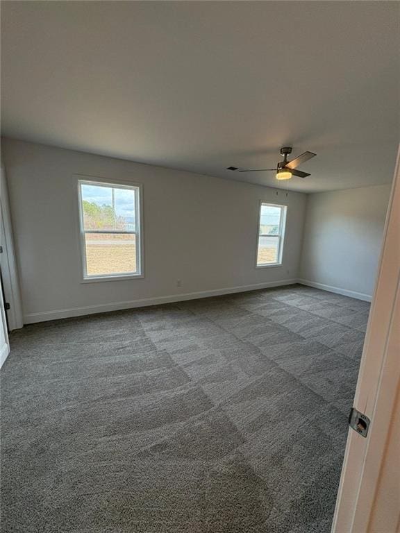 spare room featuring carpet floors and ceiling fan