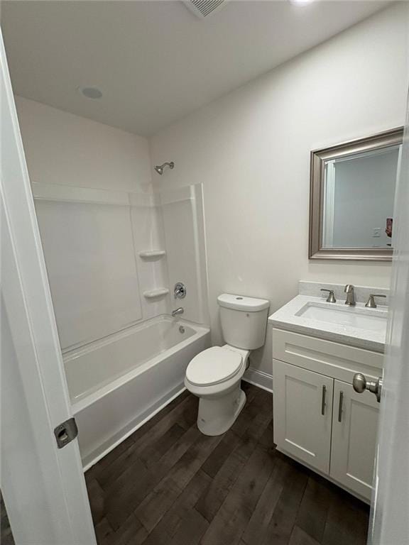 full bathroom featuring vanity, toilet, hardwood / wood-style floors, and shower / bathing tub combination