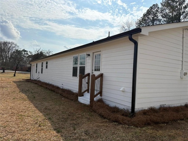 view of property exterior featuring a lawn