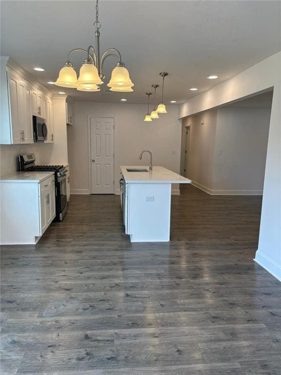 kitchen featuring decorative light fixtures, white cabinets, and appliances with stainless steel finishes