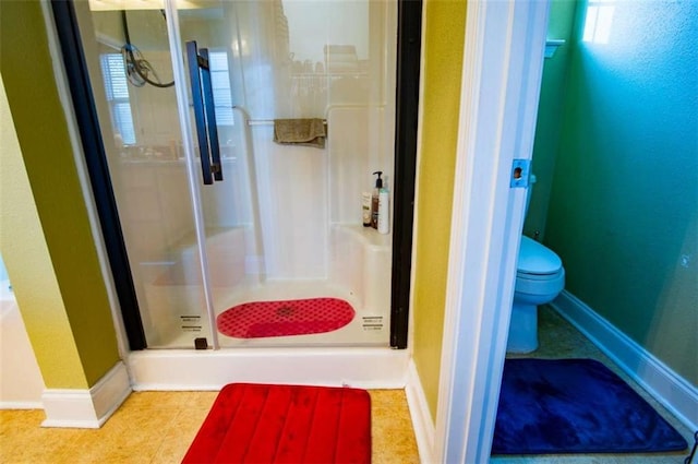 bathroom with tile patterned flooring, toilet, and a shower